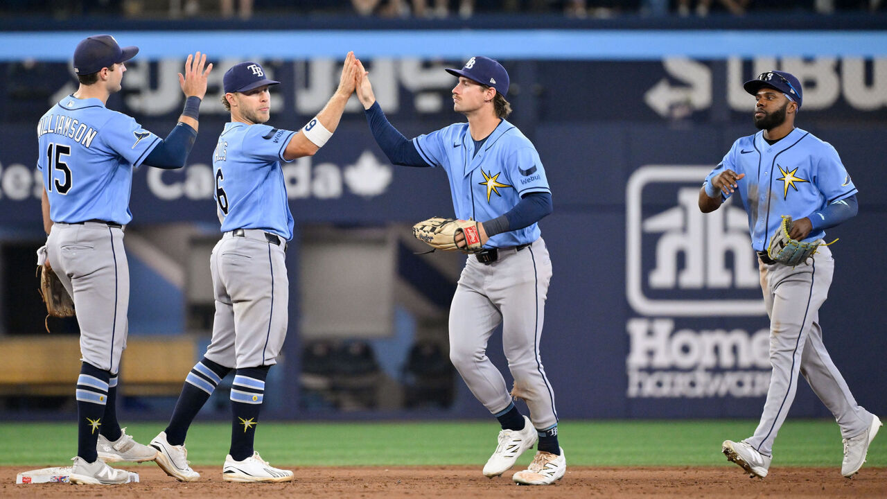 TORONTO, ON - JULY 21: Cedric Mullins #31, Jonny DeLuca #21, Taylor Walls #6 and Ben Williamson #15 of the Tamp Bay Rays celebrate after winning the game between the Tampa Bay Rays and the Toronto Blue Jays at Rogers Centre on Tuesday, July 21, 2026 in Toronto, Ontario, Canada.