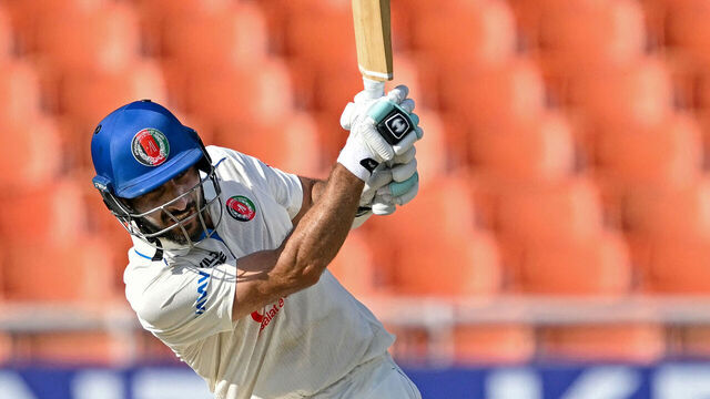 Afghanistan's Rahmat Shah plays a shot during the second day of the only Test cricket match between India and Afghanistan at the Maharaja Yadavindra Singh International Cricket Stadium on the outskirts of Chandigarh on June 7, 2026. / -- IMAGE RESTRICTED TO EDITORIAL USE - STRICTLY NO COMMERCIAL USE --