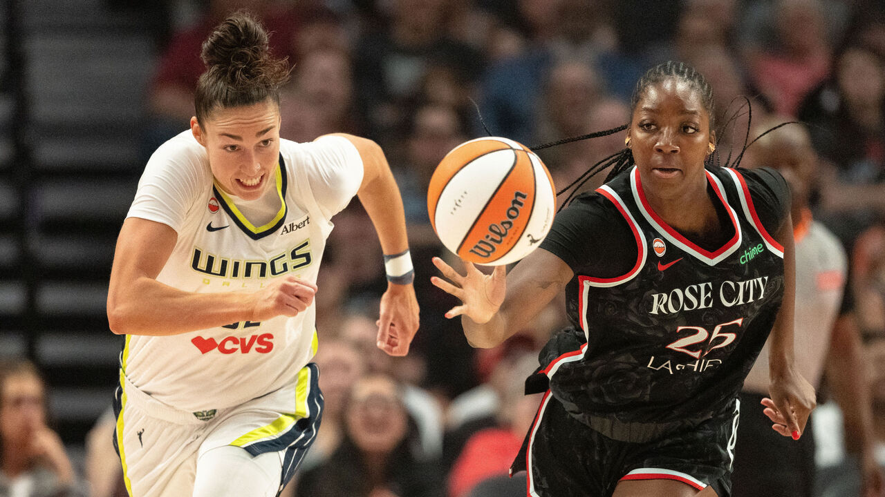 PORTLAND, OREGON - JULY 22: Serah Williams #25 of the Portland Fire gains possession of a loose ball against Jessica Shepard #32 of the Dallas Wings during the first half of the game at Moda Center on July 22, 2026 in Portland, Oregon.