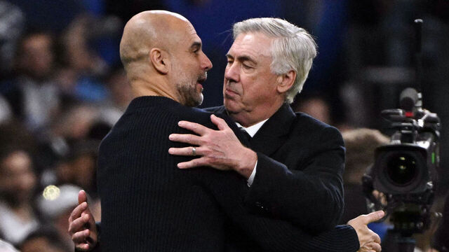 Manchester City's Spanish coach Pep Guardiola and Real Madrid's Italian coach Carlo Ancelotti hug each other at the end of the UEFA Champions League knockout phase play-off football match between Real Madrid CF and Manchester City at the Santiago Bernabeu stadium in Madrid on February 19, 2025.