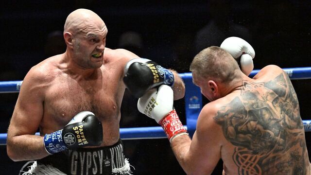 Britain's Tyson Fury (L) and Poland's Mariusz Wach (R) trade blows during their heavyweight charity boxing bout in Pattaya on July 24, 2026.