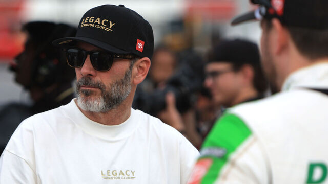 NORTH WILKESBORO, NC - JULY 18: Jimmie Johnson talks with members of Legacy Motor Club on pit road prior to practice for the NASCAR Cup Series Window World 450 on July 18, 2026 at North Wilkesboro Speedway in North Wilkesboro, NC.