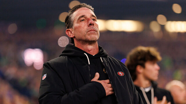 SEATTLE, WASHINGTON - JANUARY 17: Head coach Kyle Shanahan of the San Francisco 49ers stands on the sidelines during the national anthem prior to an NFL divisional playoff football game against the Seattle Seahawks at Lumen Field on January 17, 2026 in Seattle, Washington.