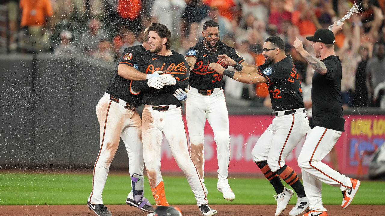 BALTIMORE, MARYLAND - JULY 25: Dylan Beavers #12 of the Baltimore Orioles celebrates hitting a walk-off single in the ninth inning with teammates during the baseball game against the Atlanta Braves at Oriole Park at Camden Yards on July 25, 2026 in Baltimore, Maryland.