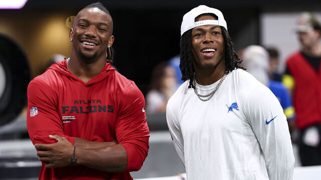 ATLANTA, GEORGIA - AUGUST 8: Bijan Robinson #7 of the Atlanta Falcons smiles with Jahmyr Gibbs #0 of the Detroit Lions prior to an NFL preseason football game at Mercedes-Benz Stadium on August 8, 2025 in Atlanta, Georgia.