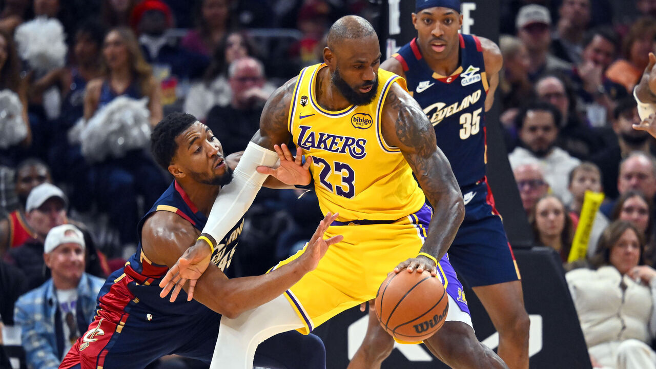 CLEVELAND, OHIO - JANUARY 28: Donovan Mitchell #45 of the Cleveland Cavaliers guards LeBron James #23 of the Los Angeles Lakers during the fourth quarter at Rocket Arena on January 28, 2026 in Cleveland, Ohio. The Cavaliers defeated the Lakers 129-99.
