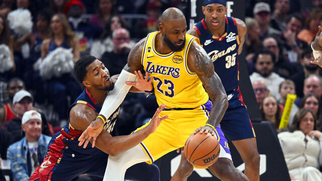 CLEVELAND, OHIO - JANUARY 28: Donovan Mitchell #45 of the Cleveland Cavaliers guards LeBron James #23 of the Los Angeles Lakers during the fourth quarter at Rocket Arena on January 28, 2026 in Cleveland, Ohio. The Cavaliers defeated the Lakers 129-99.