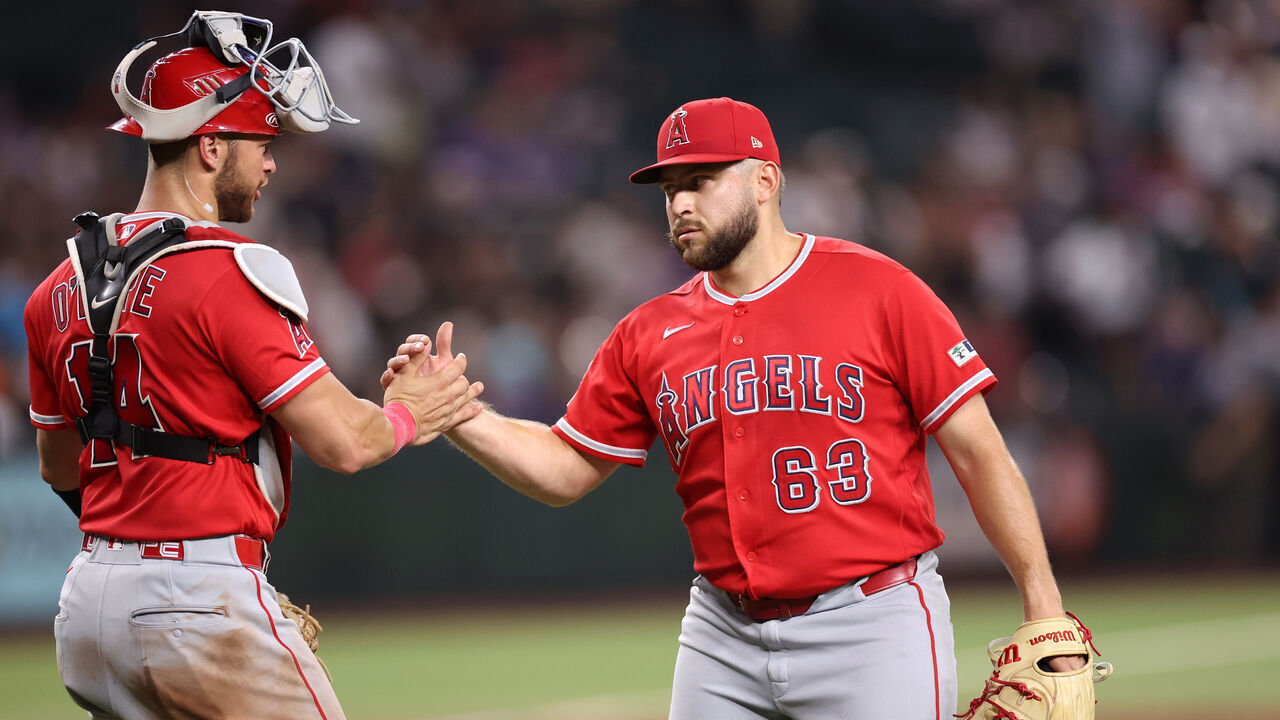 PHOENIX, ARIZONA - JUNE 16: Relief pitcher Chase Silseth #63 shakes hands with Logan O'Hoppe #14 of the Los Angeles Angels after defeating the Arizona Diamondbacks 7-0 at Chase Field on June 16, 2026 in Phoenix, Arizona.