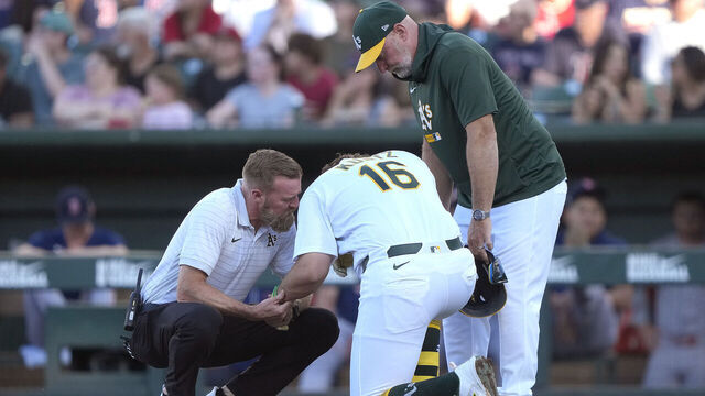 SACRAMENTO, CALIFORNIA - JULY 29: Nick Kurtz #16 of the Athletics is looked over by trainer Jeff Collins and manager Mark Kotsay #7 after being hit in the arm with a pitch against the Boston Red Sox in the bottom of the first inning at Sutter Health Park on July 29, 2026 in Sacramento, California.