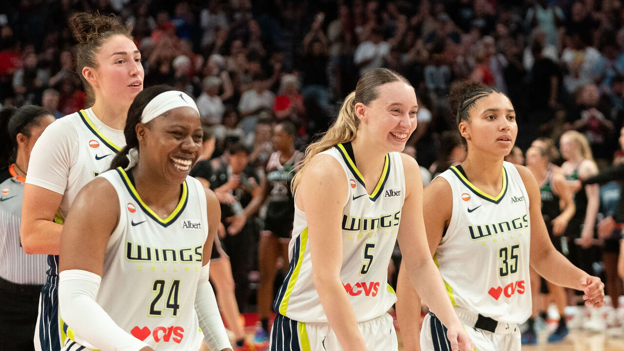 PORTLAND, OREGON - JULY 22: Arike Ogunbowale #24, Jessica Shepard #32, Paige Bueckers #5, and Azzi Fudd #35 of the Dallas Wings react after their win over the Portland Fire at Moda Center on July 22, 2026 in Portland, Oregon.