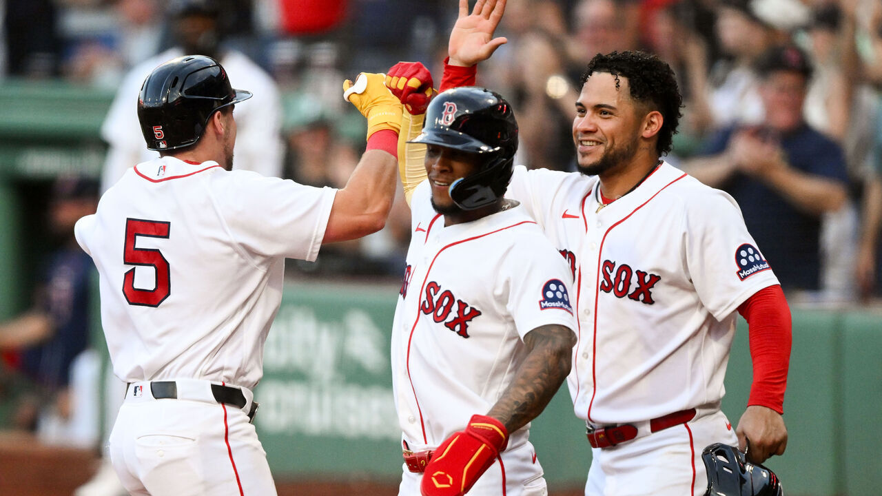 BOSTON, MASSACHUSETTS - AUGUST 04: Caleb Durbin #5 of the Boston Red Sox celebrates with Ceddanne Rafaela #3 and Willson Contreras #40 after hitting a grand slam home run against the Chicago White Sox during the first inning at Fenway Park on August 04, 2026 in Boston, Massachusetts.