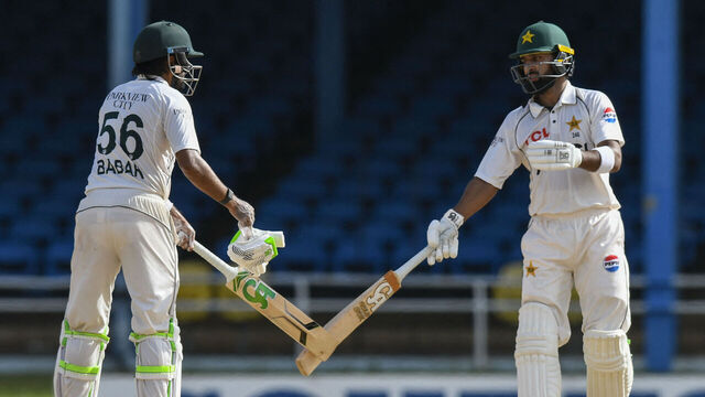 Pakistan's Babar Azam (L) and Abdullah Shafique (R) tap bats during the second day of the second Test match between West Indies and Pakistan at Queen's Park Oval in Port of Spain, Trinidad and Tobago, on August 3, 2026.