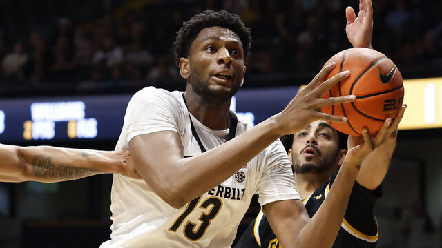 NASHVILLE, TN - NOVEMBER 15: Vanderbilt Commodores forward Jalen Washington (13) makes a move to the basket around Arkansas-Pine Bluff Golden Lions guard Alex Mirhosseini (1) during a game between the Vanderbilt Commodores and Arkansas-Pine Bluff Golden Lions, November 15, 2025, at Memorial Gymnasium in Nashville, Tennessee.