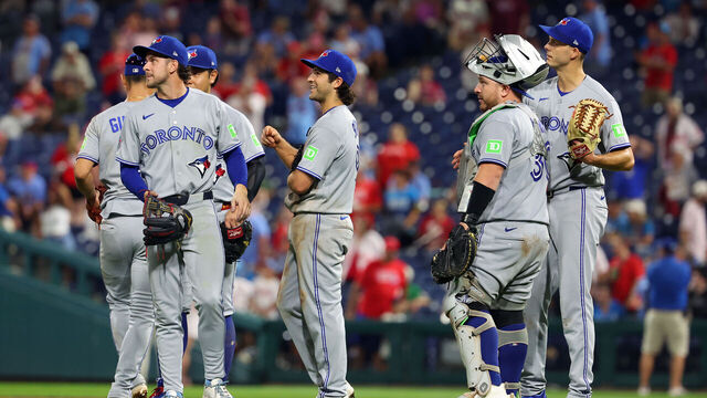 PHILADELPHIA, PENNSYLVANIA - AUGUST 7: Toronto Blue Jays players wait the result of a game deciding managers challenge in the ninth inning during a game against the Philadelphia Phillies at Citizens Bank Park on August 7, 2026 in Philadelphia, Pennsylvania. The Blue Jays won 5-4.