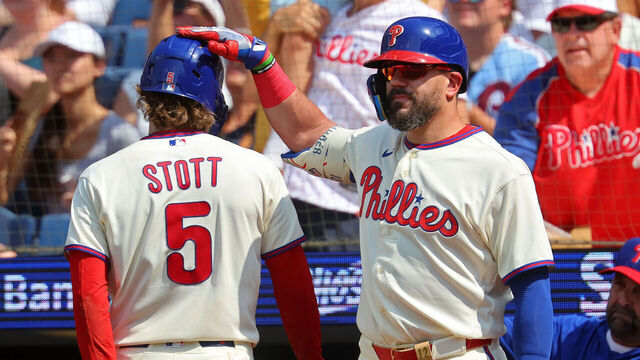 PHILADELPHIA, PENNSYLVANIA - AUGUST 9: Bryson Stott #5 of the Philadelphia Phillies is congratulated by teammate Kyle Schwarber #12 after scoring a run in the sixth inning during a game against the Toronto Blue Jays at Citizens Bank Park on August 9, 2026 in Philadelphia, Pennsylvania. The Phillies won 7-6 in 12 innings.