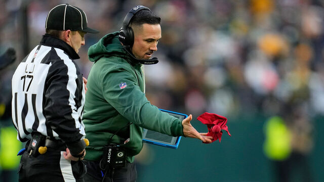 GREEN BAY, WISCONSIN - DECEMBER 07: Head coach Matt LaFleur of the Green Bay Packers throws the challenge flag during the game against the Chicago Bears at Lambeau Field on December 07, 2025 in Green Bay, Wisconsin.