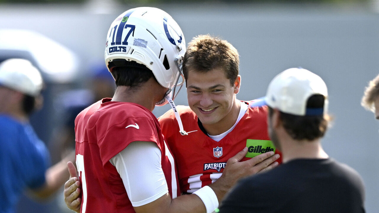 FOXBOROUGH, MASSACHUSETTS - AUGUST 11: Drake Maye #10 of the New England Patriots reacts with Daniel Jones #17 of the Indianapolis Colts during a joint practice at Gillette Stadium on August 11, 2026 in Foxborough, Massachusetts.