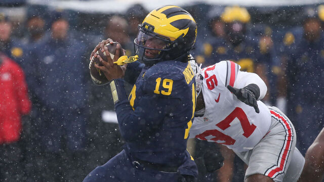 ANN ARBOR, MI - NOVEMBER 29: Michigan Wolverines quarterback Bryce Underwood (19) tries to avoid being tackled by Ohio State Buckeyes defensive end Kenyatta Jackson Jr. (97) during the fourth quarter of a regular season Big Ten Conference college football game between the Ohio State Buckeyes and the Michigan Wolverines on November 29, 2025 at Michigan Stadium in Ann Arbor, Michigan.