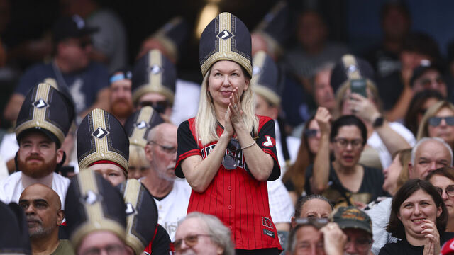 CHICAGO, ILLINOIS - AUGUST 11: A Chicago White Sox fan cheers in a Pope-themed giveaway hat before a game against the Cincinnati Reds at Rate Field on August 11, 2026 in Chicago, Illinois.