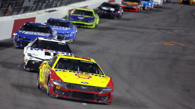 NORTH WILKESBORO, NORTH CAROLINA - MAY 18: Joey Logano, driver of the #22 Shell Pennzoil Ford, and Christopher Bell, driver of the #20 Mobil 1 Toyota, race during the NASCAR Cup Series All-Star Race at North Wilkesboro Speedway on May 18, 2025 in North Wilkesboro, North Carolina.