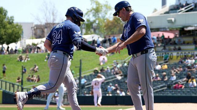 SACRAMENTO, CALIFORNIA - AUGUST 12: Liam Hicks #34 of the Tampa Bay Rays trotting around the bases is congratulated by third base coach Brady Williams #4 after Hicks hit a three-run home run against the Athletics in the top of the fourth inning at Sutter Health Park on August 12, 2026 in Sacramento, California.