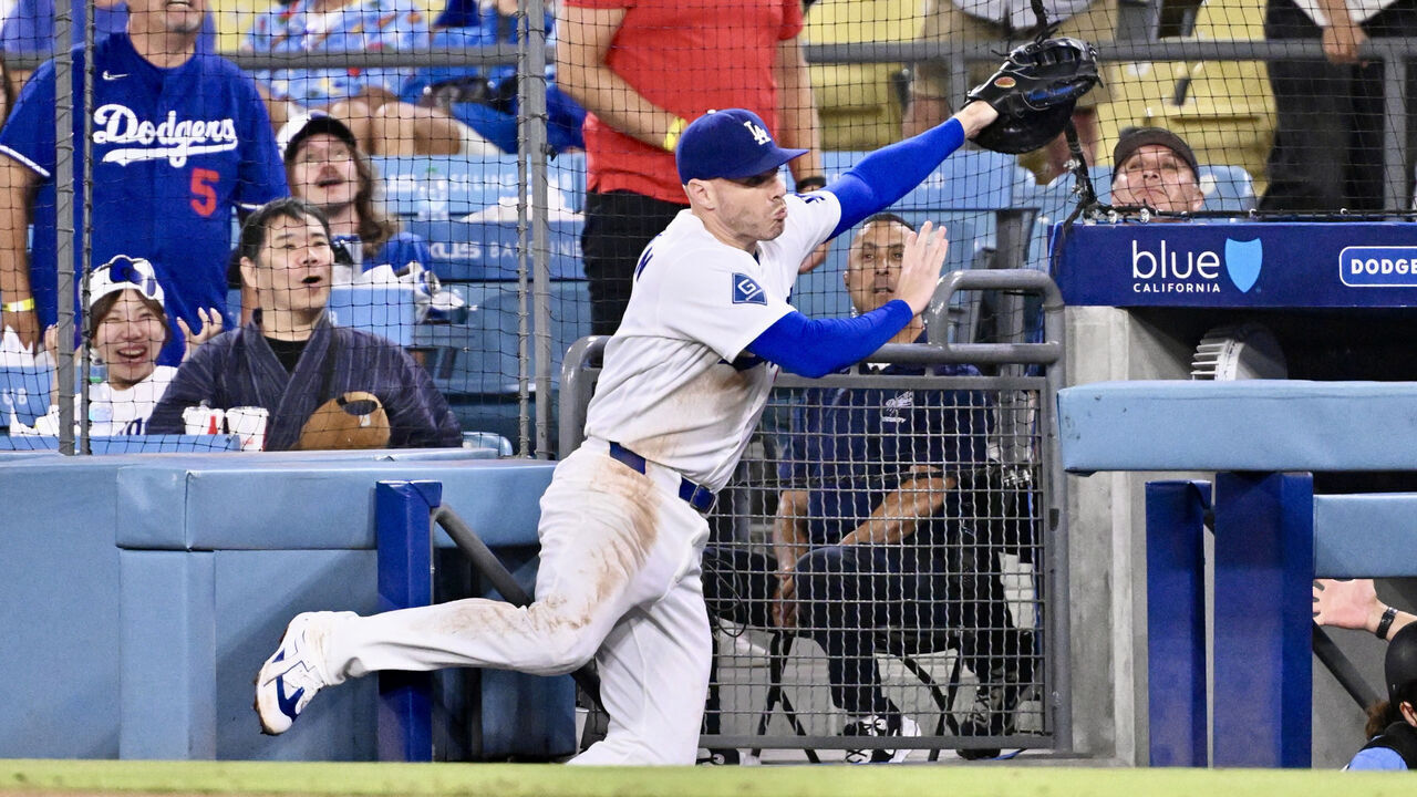 Los Angeles, - August 12: Freddie Freeman #5 of the Los Angeles Dodgers falls into the dugout while chasing a foul ball off the bat of Isaac Collins (not pictured) of the Kansas City Royals in the eighth inning of a baseball game at Dodger Stadium in Los Angeles on Wednesday, August 12, 2026.