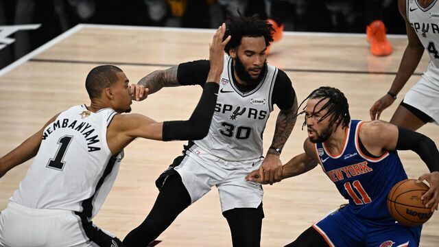 Victor Wembanyama L and Julian ChampagnieC of San Antonio Spurs defend Jalen Brunson of New York Knicks during the final game 5 between New York Knicks and San Antonio Spurs at the 2025-2026 NBA basketball game in San Antonio, the United States, June 13, 2026.