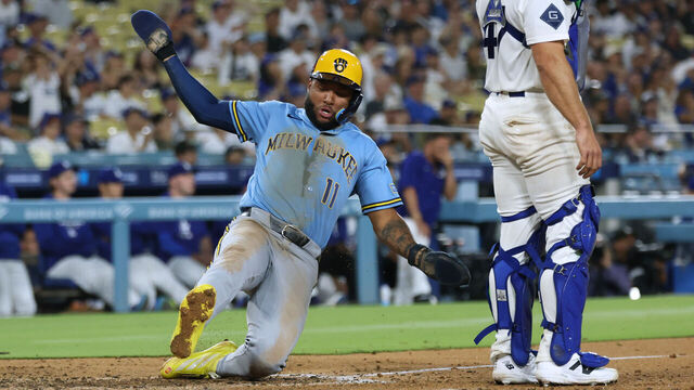 LOS ANGELES, CALIFORNIA - AUGUST 13: Jackson Chourio #11 of the Milwaukee Brewers scores behind Ben Rortvedt #47 of the Los Angeles Dodgers, from a Jake Bauers #9 hit, to take a 5-4 lead, during the ninth inning at Dodger Stadium on August 13, 2026 in Los Angeles, California.