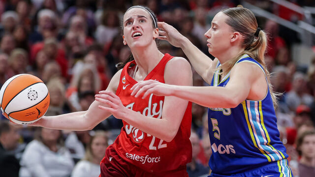 INDIANAPOLIS, INDIANA - AUGUST 14: Caitlin Clark #22 of the Indiana Fever drives to the basket against Paige Bueckers #5 of the Dallas Wings during the first half at Gainbridge Fieldhouse on August 14, 2026 in Indianapolis, Indiana.