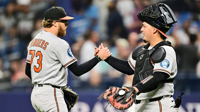 ST PETERSBURG, FLORIDA - AUGUST 14: Cam Sanders #73 of the Baltimore Orioles celebrates with Yohel Pozo #79 after defeating the Tampa Bay Rays 6-5 at Tropicana Field on August 14, 2026 in St Petersburg, Florida.
