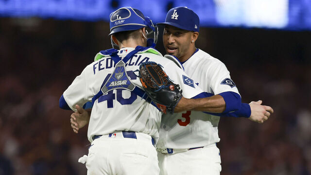 LOS ANGELES, CA - AUGUST 14: Edwin Díaz #3 of the Los Angeles Dodgers hugs Hunter Feduccia #46 after defeating the Milwaukee Brewers at UNIQLO Field at Dodger Stadium on Friday, August 14, 2026 in Los Angeles, California.