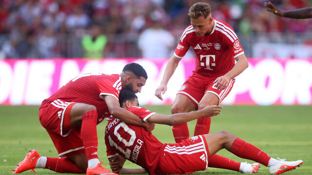 MUNICH, GERMANY - AUGUST 15: Ismael Saibari and Joshua Kimmich of Bayern Munich help teammate Jamal Musiala after going to ground during the Telekom Cup match between FC Bayern München and RB Leipzig at Allianz Arena on August 15, 2026 in Munich, Germany.