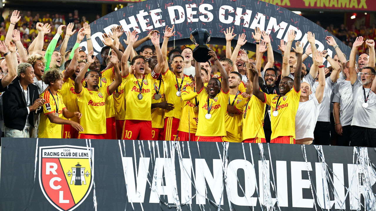 LENS, FRANCE - AUGUST 16: Players of RC Lens raise the trophy on the podium after the Trophee des Champions match between RC Lens and Paris Saint-Germain at Stade Bollaert-Delelis on August 16, 2026 in Lens, France.