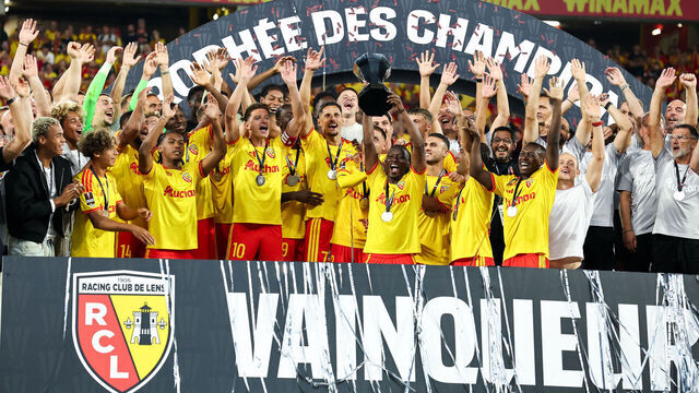 LENS, FRANCE - AUGUST 16: Players of RC Lens raise the trophy on the podium after the Trophee des Champions match between RC Lens and Paris Saint-Germain at Stade Bollaert-Delelis on August 16, 2026 in Lens, France.