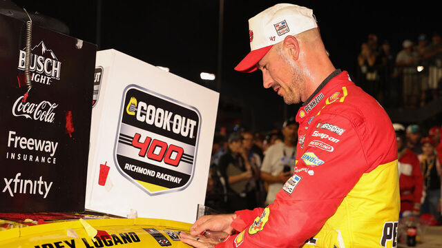 RICHMOND, VIRGINIA - AUGUST 15: Joey Logano, driver of the #22 Shell Pennzoil Ford, places the winner sticker on his car after winning the NASCAR Cup Series Cook Out 400 at Richmond Raceway on August 15, 2026 in Richmond, Virginia.