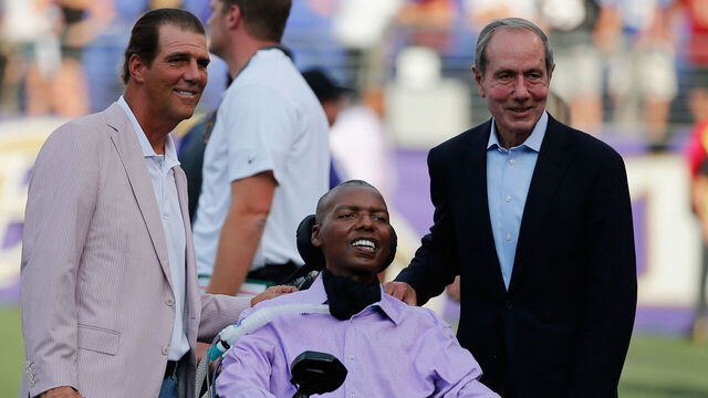 BALTIMORE, MD - AUGUST 13: Baltimore Ravens owner Steve Bisciotti (L) and president Dick Cass (R) pose for a photo with former Ravens player O.J. Brigance before the start of a preseason game against the New Orleans Saints at M&T Bank Stadium on August 13, 2015 in Baltimore, Maryland.