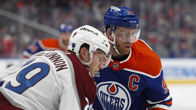 EDMONTON, CANADA - APRIL 13: Connor McDavid #97 of the Edmonton Oilers faces off against Nathan MacKinnon #29 of the Colorado Avalanche during the third period at Rogers Place on April 13, 2026 in Edmonton, Canada.