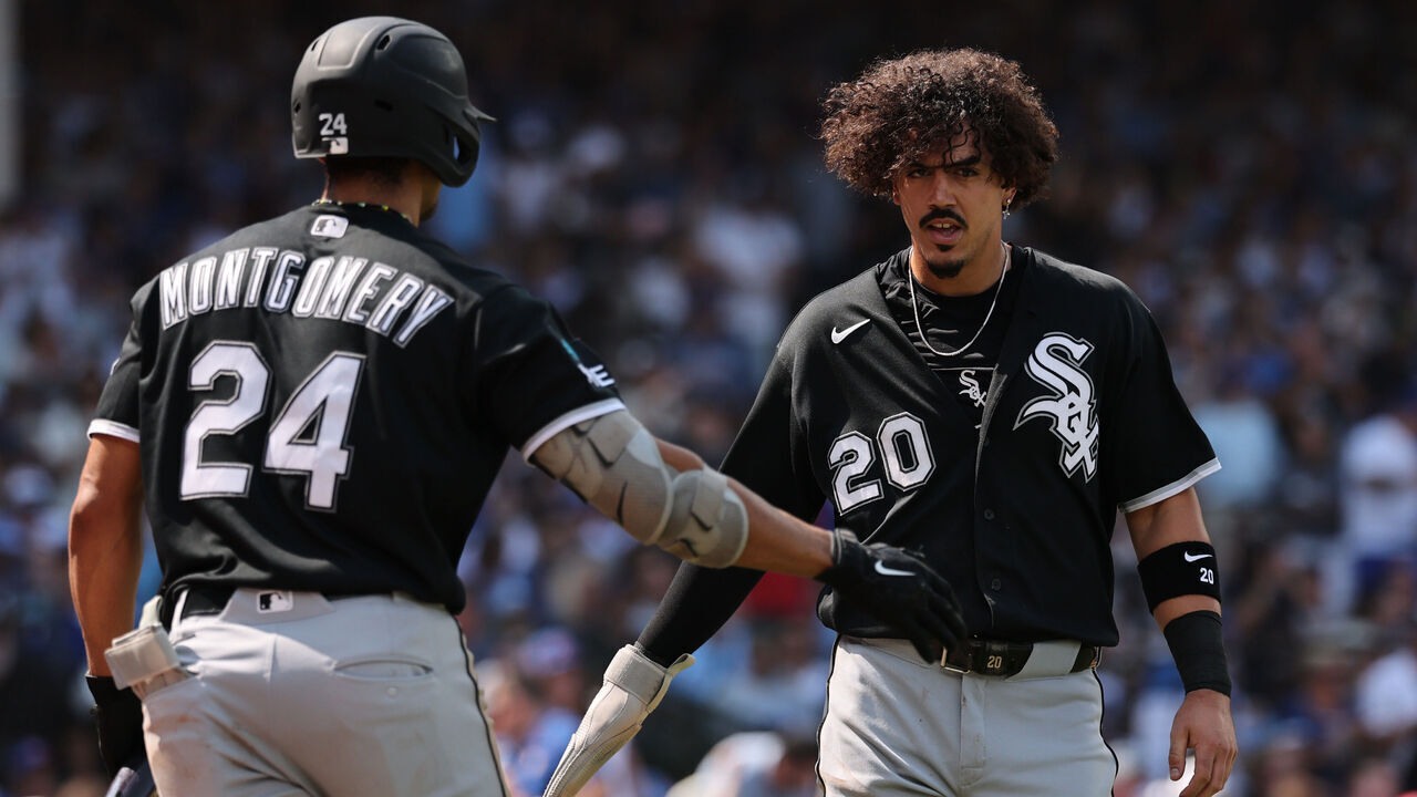 CHICAGO, ILLINOIS - AUGUST 19: Miguel Vargas #20 of the Chicago White Sox high fives Braden Montgomery #24 after scoring a run against the Chicago Cubs during the sixth inning at Wrigley Field on August 19, 2026 in Chicago, Illinois.