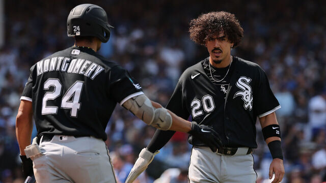 CHICAGO, ILLINOIS - AUGUST 19: Miguel Vargas #20 of the Chicago White Sox high fives Braden Montgomery #24 after scoring a run against the Chicago Cubs during the sixth inning at Wrigley Field on August 19, 2026 in Chicago, Illinois.