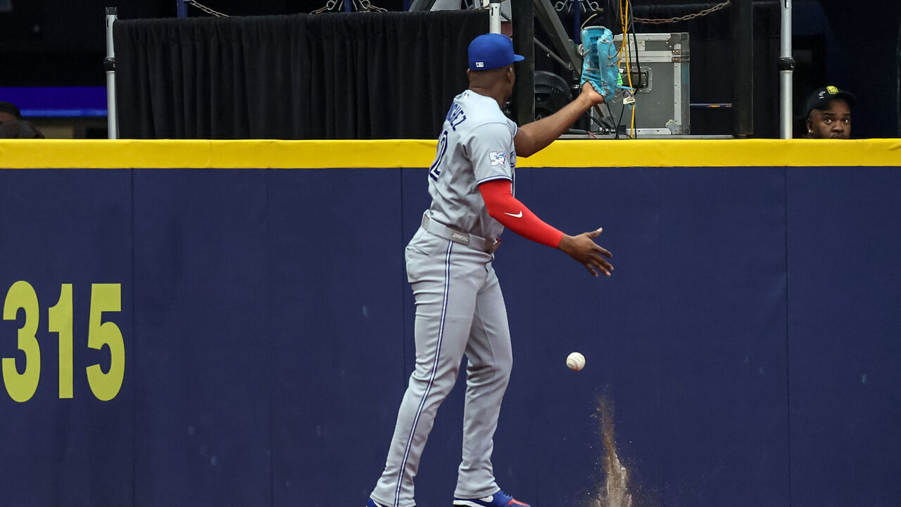 ST. PETERSBURG, FL - AUGUST 19: Jesús Sánchez #12 of the Toronto Blue Jays misses a fly ball from Junior Caminero #13 of the Tampa Bay Rays (not pictured) which bounced over the fence for a ground rule double during the first inning of the baseball game at Tropicana Field on August 19, 2026 in St. Petersburg, Florida.