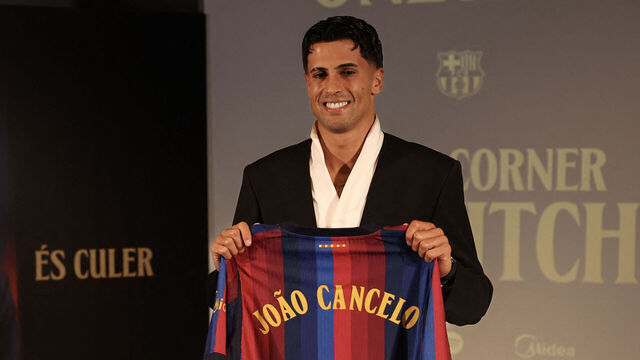 Portuguese international footballer Joao Cancelo poses with a Barcelona jersey during his official presentation as FC Barcelona's new player at the Nou Camp in Barcelona on August 20, 2026.