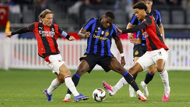 PERTH, AUSTRALIA - AUGUST 05: Ange-Yoan Bonny of FC Internazionale attempts to protect the ball from Koni De Winter and Luka Modrić of AC Milan during the pre-season match between AC Milan and FC Internazionale at Optus Stadium on August 05, 2026 in Perth, Australia.