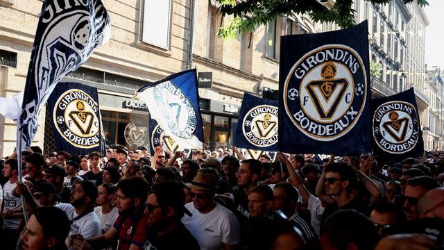 Supporters of French 'Nationale 2' fourth-tier club FC Girondins de Bordeaux wave the club's flags during a protest ahead of a hearing at the Direction Nationale du Controle de Gestion - DNGG, French football financial watchdog, following the six-time French champions' exclusion from national competitions, in Bordeaux, southwestern France July 19, 2026. Unless club officials secure a solution, Girondins de Bordeaux, also three-time French Cup winners, will be relegated to regional-level football following the DNCG's decision.