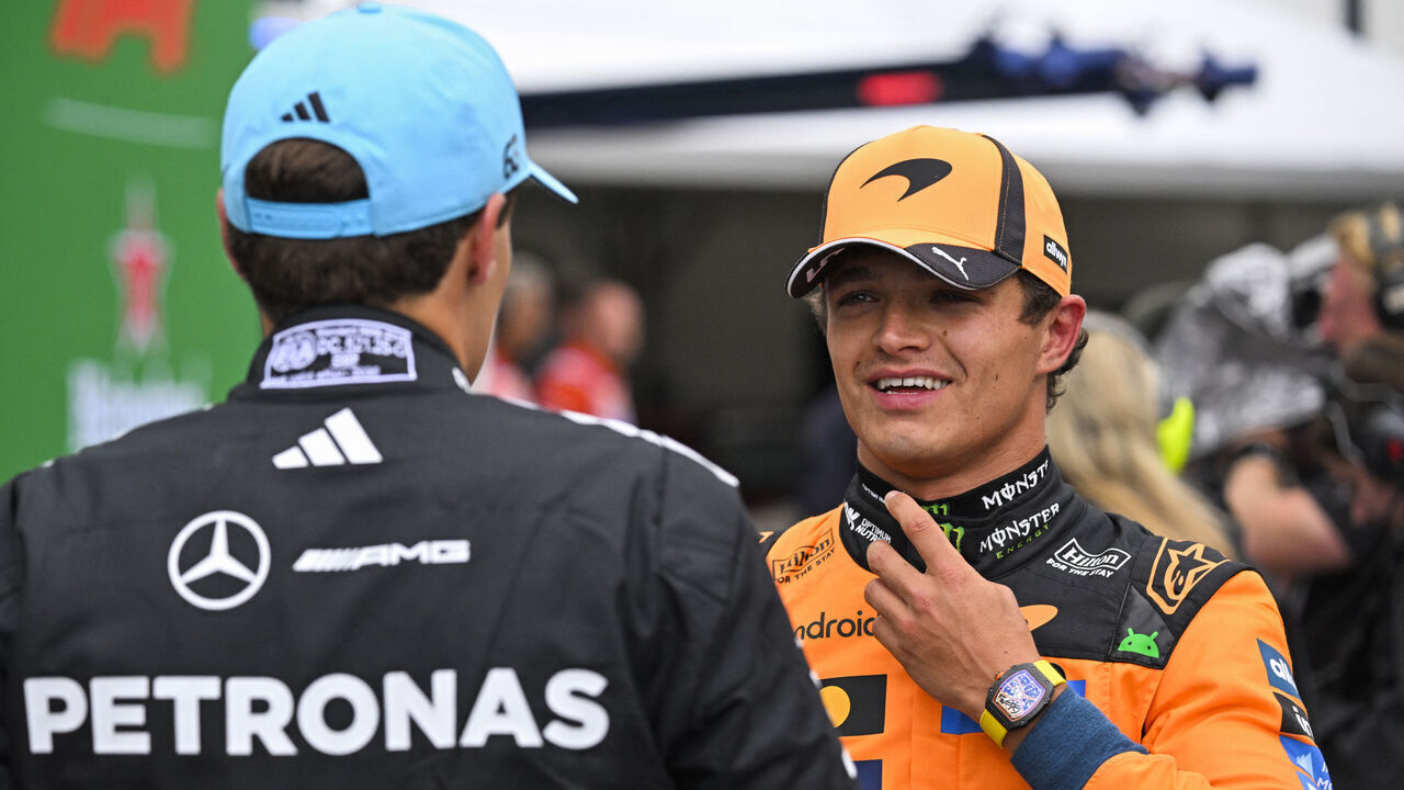 P1 McLaren's British driver Lando Norris (R) speaks with P2 Mercedes' British driver George Russell after the qualifying race of the Formula One Dutch Grand Prix at The Circuit Zandvoort, western Netherlands, on August 22, 2026.