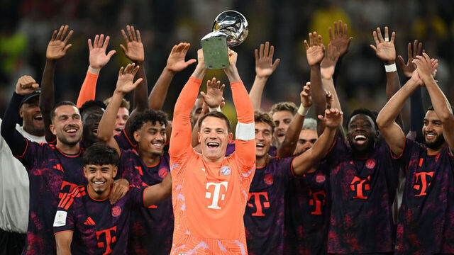 DORTMUND, GERMANY - AUGUST 22: Manuel Neuer of Bayern Munich lifts the Franz Beckenbauer Supercup trophy after the Franz Beckenbauer Supercup match between Borussia Dortmund and FC Bayern München at Signal Iduna Park on August 22, 2026 in Dortmund, Germany.