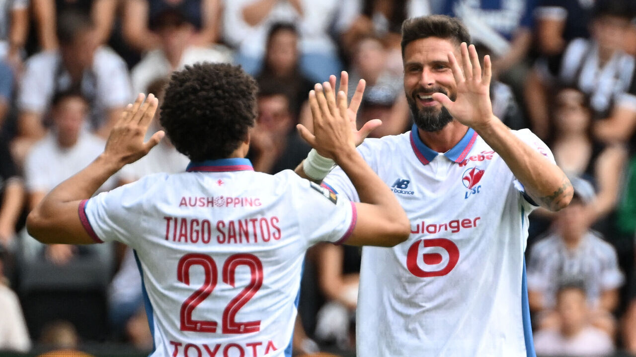 Lille's Portuguese defender #22 Tiago Santos (L) celebrates with teammates after scoring his team's first goal during the French L1 football match between Angers SCO and LOSC Lille at the Stade Raymond Kopa in Angers, western France on August 23, 2026.
