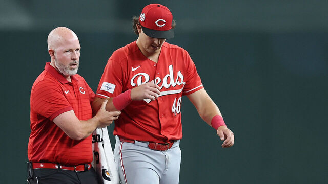 PHOENIX, ARIZONA - AUGUST 21: Michael Toglia #48 of the Cincinnati Reds is helped off the field after making a diving catch against the Arizona Diamondbacks during the first inning of the MLB game at Chase Field on August 21, 2026 in Phoenix, Arizona.