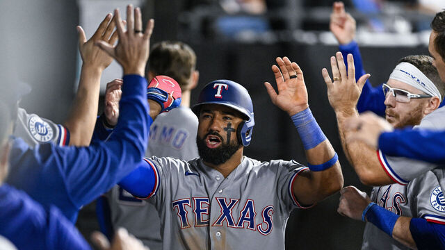 CHICAGO, ILLINOIS - AUGUST 24: Ezequiel Duran #20 of the Texas Rangers receives high fives in the dugout after scoring on a wild pitch during the eighth inning against the Chicago White Sox at Rate Field on August 24, 2026 in Chicago, Illinois.