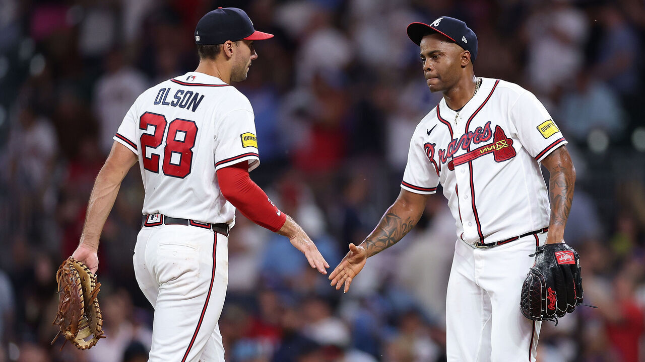 ATLANTA, GEORGIA - AUGUST 11: Raisel Iglesias #26 and Matt Olson #28 of the Atlanta Braves react after their 4-0 win over the New York Mets at Truist Park on August 11, 2026 in Atlanta, Georgia.