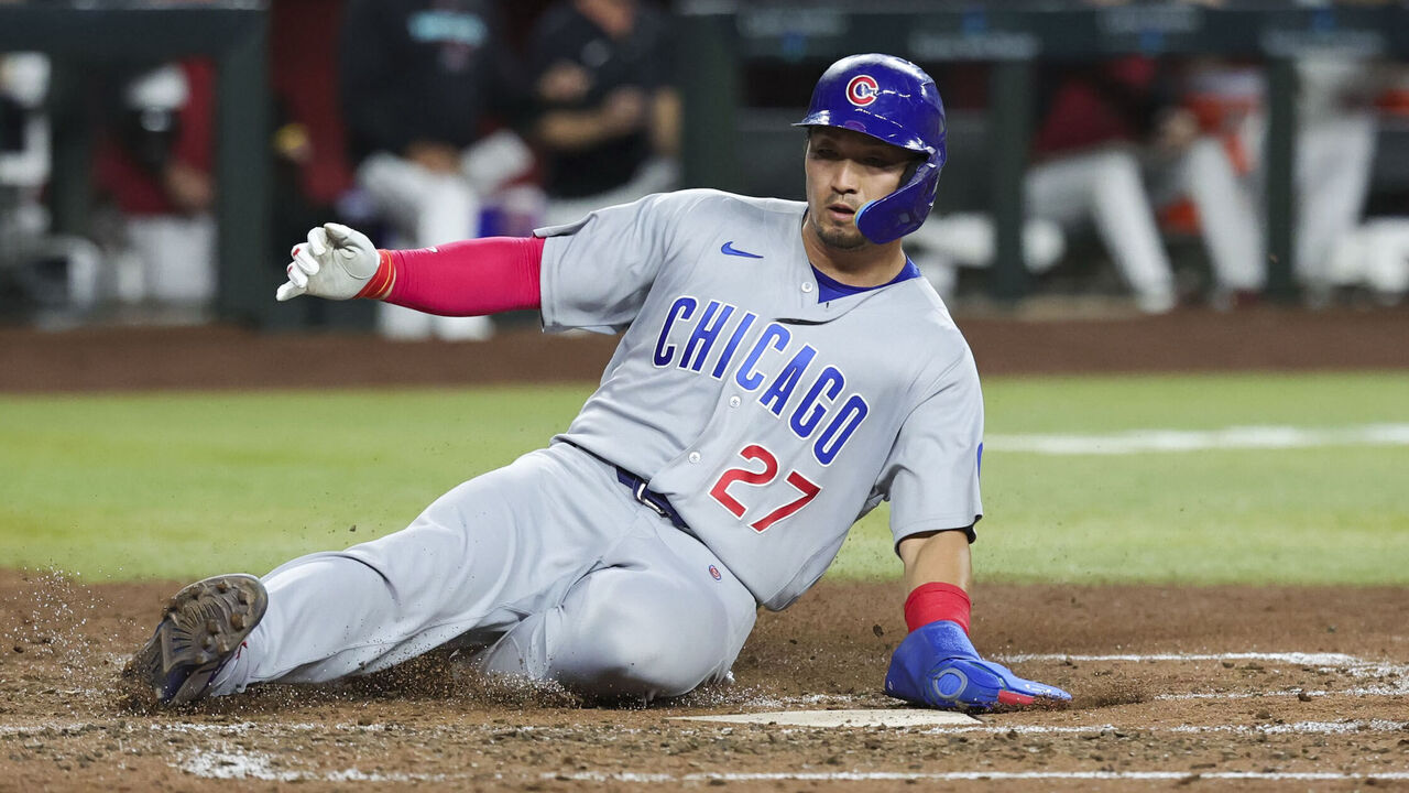 PHOENIX, AZ - AUGUST 25: Seiya Suzuki #27 of the Chicago Cubs slides into home to score in the sixth inning during the game between the Chicago Cubs and the Arizona Diamondbacks at Chase Field on Tuesday, August 25, 2026 in Phoenix, Arizona.